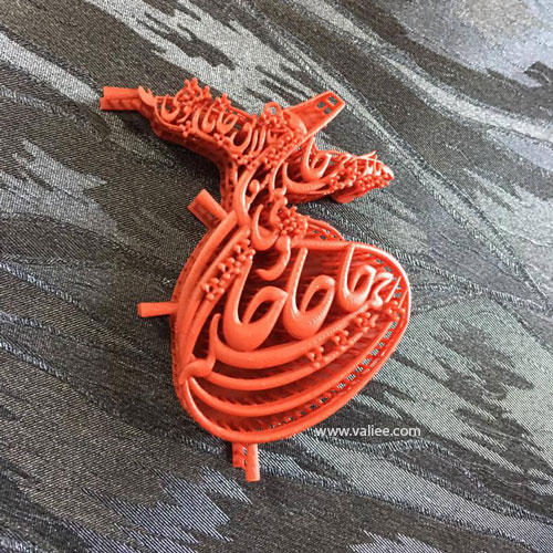 Orange resin prototype of a calligraphy pendant testing scale, rhythm and movement, designed by Mehdi Valiee